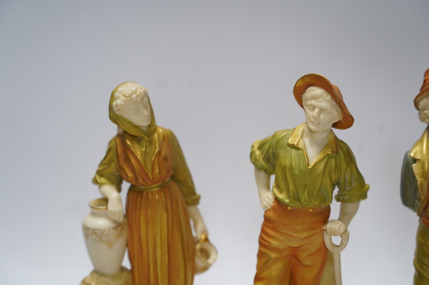 Four Worcester figures comprising 1874, 1810 and 835, one signed Hadley, largest 17cm high. Condition - good